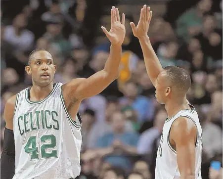  ?? STaFF PhOTO By MaTT sTONE ?? TWO GOOD: Al Horford celebrates with Avery Bradley during the Celtics' win over the Pacers last night.