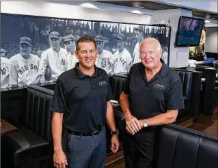  ?? PHOTOS BY RICHARD GRAULICH / THE PALM BEACH POST ?? Owners Ryan Witkowski (left) and his father, Dennis, show a visitor around the newly renovated Stadium Grill in downtown Abacoa last week.