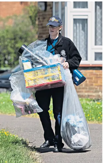  ??  ?? A police officer carries out bagged items from a property in Havant where Louise Smith was staying before she vanished on May 8