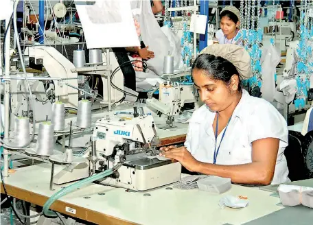  ??  ?? File picture of a worker at a garments factory.