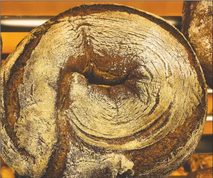  ??  ?? A bread loaf baked with beer is displayed in the Coelven bakery.