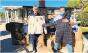  ?? COURTESY PHOTO ?? Jeffrey Olsen (left) and Phillip Sammuli, of S.D. Armed Ser vices YMCA, hold gifts for families.