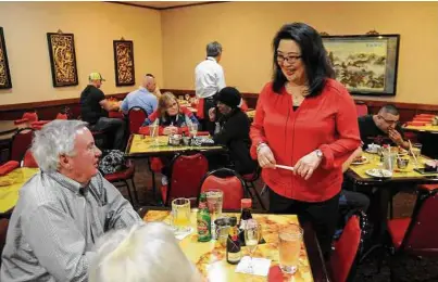  ?? Dave Rossman photos ?? Carol Jue Churchill talks with customers at China Garden. Located within walking distance of Toyota Center, the restaurant is billed as the city’s oldest Chinese diner.