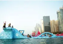  ??  ?? HOLIDAY DESTINATIO­N: Families enjoy the amenities at a water park in front of Jumeirah Beach Towers in Dubai, United Arab Emirates. (AP)