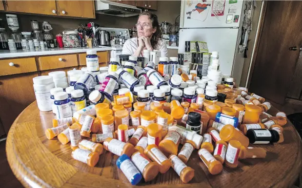  ?? PETER J. THOMPSON / NATIONAL POST ?? Mary Shuttlewor­th sits in her kitchen at her Dundalk home with medication bottles she has consumed in the past year to help deal with injuries she sustained in a car crash in 2012. A decision to deny her coverage “did not reflect the independen­t...