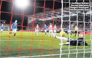  ??  ?? Confident: Graham Dorrans chips home Rangers’ fourth goal from the penalty spot