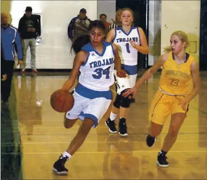  ?? FILE PHOTOS ?? Lower Lake’s Kimberly Bautista dribbles down the court as Middletown’s Sophie Kucer defends during a North Central Leageu I game held nearly a year ago today in Lower Lake. Trailing the play is Lower Lake’s Sam Hughes.