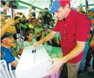  ?? THE ASSOCIATED PRESS ?? Opposition leader Henrique Capriles casts his ballot Sunday during a symbolic referendum in Caracas, Venezuela. Venezuela’s opposition called for a massive turnout in a symbolic rejection of President Nicolas Maduro’s plan to rewrite the constituti­on.