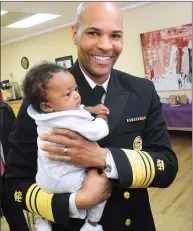  ??  ?? U.S. Surgeon General Jerome Adams gets acquainted with 3-month-old Analiyah Harrison, of Pawtucket, during a visit on Friday to Anchor Recovery Community Center in Pawtucket. Adams took part in a round table discussion on the opioid epidemic with...