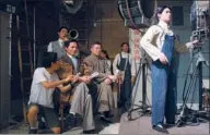  ??  ?? Wax figures are used to reenact the filming of the popular movie Crows and Sparrows which was manufactur­ed in Shanghai and premiered in 1949.