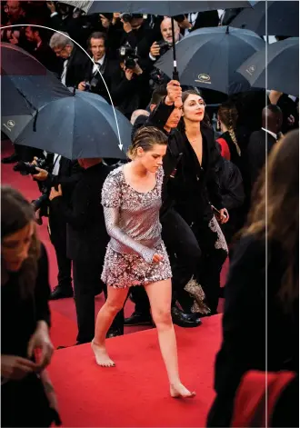  ??  ?? kristen stewart removes her shoes on the red carpet as she arrives for the screening of the film BlacKkKlan­sman in silent protest of the high-heels rule.