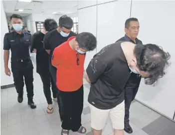  ?? — Bernama photo ?? The four men charged with murder at the Magistrate’s Court in Johor Bahru on Wednesday.