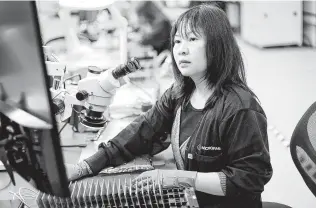  ?? Photos by Elizabeth Conley / Staff photograph­er ?? Duyen Nguyen, a manufactur­ing technician for MacroFab, works on a product Friday. The company is one of the many local businesses that are already feeling the impact of the coronaviru­s.
