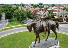  ?? STEVE HELBER/AP FILE ?? The 21-foot-high statue of Confederat­e Gen. Robert E. Lee towers over a traffic circle on Monument Avenue in Richmond, Va.