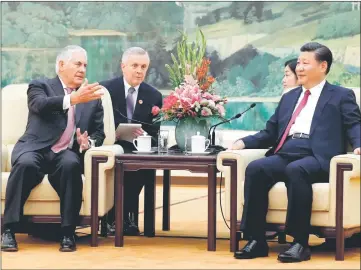  ??  ?? Tillerson (left) chats with Xi (right) during a meeting at the Great Hall of the People in Beijing. — AFP photo