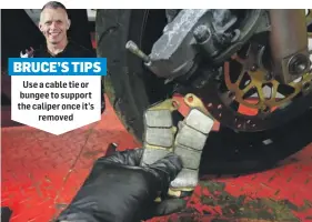  ??  ?? Use a cable tie or bungee to support the caliper once it’s removed