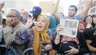  ?? Remy de la Mauviniere/the Associated Press ?? Muslims pay homage to French mountainee­r Herve Gourdel during a gathering in front of the Paris Grand Mosque, Friday. Gourdel was beheaded by Islamist militants in Algeria.