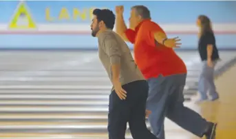  ?? TIM BOYLE/FOR THE SUN-TIMES ?? Bowlers warm up before the Fox Valley Sectional of Beat the Champions at Lisle Lanes.