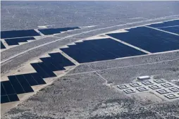 ?? ?? Aerial view of solar panels of the largest solar plant in all Latin America, which is being built by Mexican state-owned electric utility Federal Electricit­y Commission (CFE), in Puero Peñasco, Sonora state, Mexico.