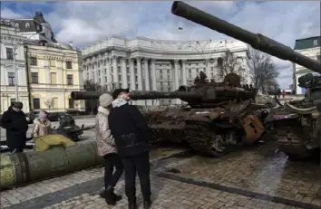  ?? Andrew Kravchenko/Associated Press ?? People look at destroyed Russian tanks and armored vehicles on display near St. Michael’s Cathedral on Sunday in downtown Kyiv, Ukraine.