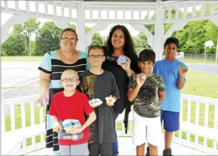  ?? BEN LAMBERT / HEARST CONNECTICU­T MEDIA ?? A group of residents has spent some of the summer painting and hiding rocks, bringing a bit of color and wonder to the community. From left: Dawn Styga, Zachary Styga, Joshua Styga, Stacy Rodriguez, Chase Rodriguez, and Jason Rodriguez.