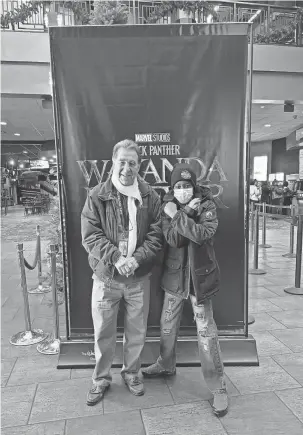  ?? ROCHELLE RILEY/FOR THE DETROIT FREE PRESS ?? Osborn High School staffer and chaperone Nazzareno DelGreco accompanie­s 12th grader Keandrea Dennis to the “Wakanda Forever” screening Tuesday. They are wearing their “48205: Pride of the Eastside” school hoodie under their coats.