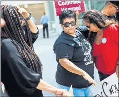  ??  ?? Laurie Valdez, center, whose partner Antonio Lopez was killed by a San Jose State University police officer in 2014, comforts Martha Silos.