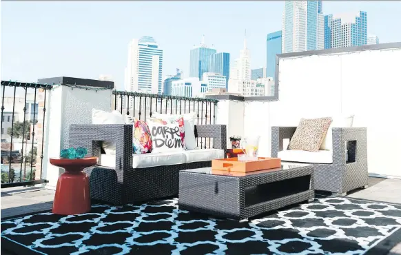  ?? HEATHER HAWKINS/ABBE FENIMORE/THE ASSOCIATED PRESS ?? An outdoor rug in a rooftop sitting area brings the softness of a living room to an outdoor space. Designers say that outdoor furnishing­s have come a long way. Look for rugs, lighting, sofas and more. Also, consider temperatur­e management, including...