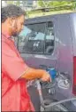  ?? AFP ?? A staff fills a car at a service station in Karachi following a rise in petroleum prices.