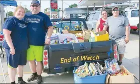  ?? (NWA Democrat-Gazette/Susan Holland) ?? Jenny and Shane Hargrave and Audrey and Michael Ratledge, organizers of the Gravette Cruise and Quarantine cruise nights, display the pickup load of school supplies that was donated during the Aug. 16 cruise night. The boxes of school supplies will be donated to Bright Futures, which will distribute the supplies where they are most needed.