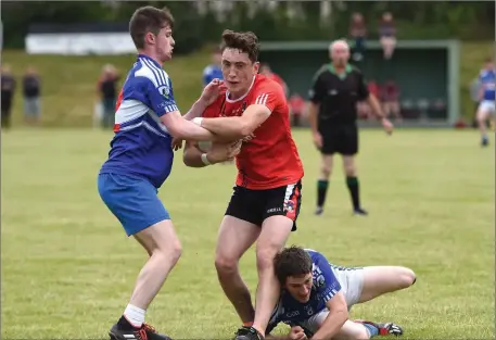  ??  ?? Fossa’s Paudie Clifford holds possession against the challenge of Ballylongf­ord’s Jack Mulvihill - with Joe McCarthy on the ground - in their County Senior Football League Division 4 game at Fossa on Sunday Photo by Michelle Cooper Galvin