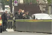  ?? Associated Press ?? Police train their weapons on a car crashed into security barriers outside the Houses of Parliament.