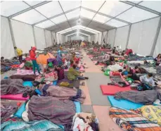  ??  ?? Central American migrants rest during a stop at a temporary shelter in a sports centre in Mexico City on Tuesday. — AFP