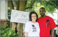  ?? KAYTIE BOOMER — SAGINAW NEWS VIA AP, FILE ?? Regina and Donald Simon pose for a photograph in front of their home in Saginaw.