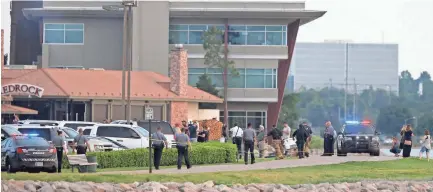  ?? BRYAN ?? Emergency personnel gather at the scene of a restaurant shooting Thursday at Lake Hefner in Oklahoma City. TERRY/THE OKLAHOMAN VIA AP