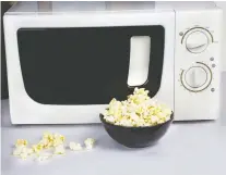  ?? GETTY IMAGES ?? DIY microwavea­ble popcorn can be made with kernels, a brown paper bag and some vegetable oil.