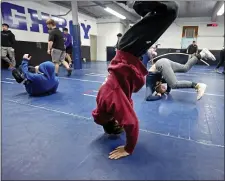  ?? STAFF PHOTO BY STUART CAHILL — BOSTON HERALD ?? Team members warm up at the Shawsheen wrestling practice on Jan. 17.