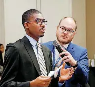  ?? [PHOTO BY JIM BECKEL, THE OKLAHOMAN] ?? J.D. Baker shares feedback on Tuesday about The Oklahoman at an Oklahoma City luncheon sponsored by the newspaper, while reporter Ben Felder holds the microphone.