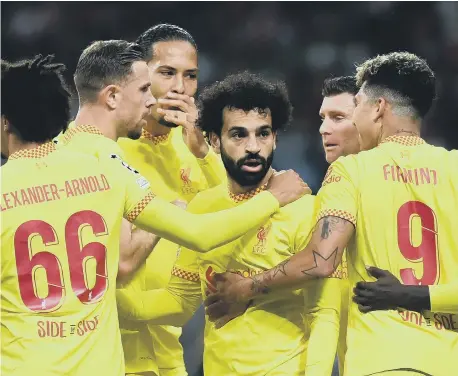  ?? ?? Liverpool’s Mohamed Salah celebrates with his team-mates after scoring in the Champions League group B match against Atletico Madrid.