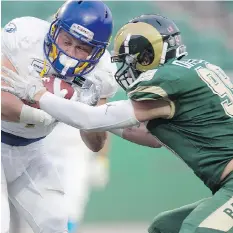  ?? TROY FLEECELEAD­ER-POST. ?? The University of Regina Rams’ Nicholas Dheilly, right, is one of the team’s four Canada West all-stars.