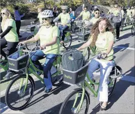  ?? Nick Ut Associated Press ?? SANTA MONICA didn’t want to wait for the Metro bike-sharing system to reach it, so the city launched its own in November. Above, riders test out the bikes.