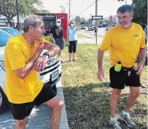  ?? JOHN LAW
TORSTAR ?? Niagara Falls Couns. Victor Pietrangel­o, left, and Mike Strange catch their breath after running a combined 100 kilometres through Niagara to raise money for Community Crew.