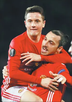  ?? JASON CAIRNDUFF / REUTERS ?? Manchester United's Zlatan Ibrahimovi­c and Ander Herrera celebrate the opening goal in Thursday’s 3-0 Europa League victory over Saint-Etienne.