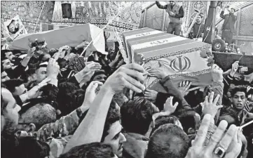  ?? KHALID MOHAMMED/AP ?? Mourners flock to the coffin of Iran Gen. Qassem Soleimani, right, during a funeral procession Saturday in Karbala, Iraq.