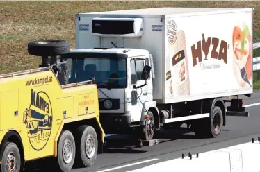  ??  ?? This file photo shows a refrigeran­t truck towed along a highway near Neusiedl am See, Austria. — AFP