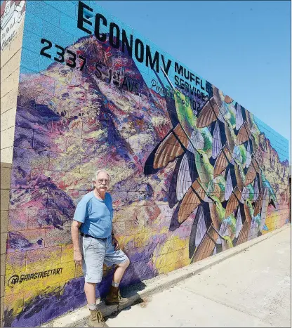  ?? Buy this photo at YumaSun.com PHOTO BY RANDY HOEFT/YUMA SUN ?? ABOVE: KEVIN DALE, OWNER OF Economy Muffler Service, 2337 S. 1st Ave., stands next to the colorful hummingbir­d mural painted by internatio­nally known street artist Gaia on the south wall of Dale’s business.