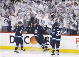  ?? The Canadian Press ?? Winnipeg Jets’ Mark Scheifele, left, Blake Wheeler, centre, and Dustin Byfuglien (33) celebrate after Wheeler’s go-ahead goal against the Nashville Predators during the third period of Game 3 in their second-round NHL playoff series on Tuesday in...