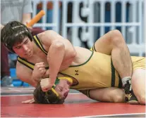  ?? CAUDILL/FREELANCE MIKE ?? First Colonial’s Thomas Stofka, top, takes control of Cox’s Parker Tillery in the Class 5 state final Saturday at the Virginia Beach Sports Center.