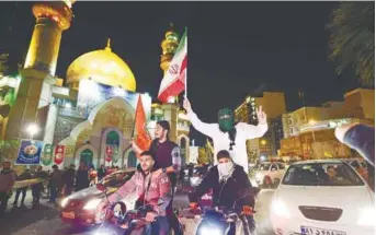  ?? AFPPIC ?? Protesters wave Iranian and Palestinia­n flags as they gather at Palestine Square in Tehran yesterday.
–