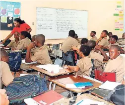  ??  ?? An all-boys class being taught by their religious education teacher, Miss Lovelace.